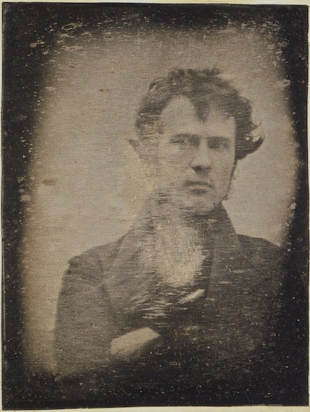 an old photo of a man with a bird on his shoulder.