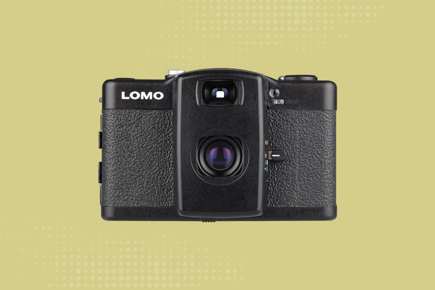 Lomography LC-A+ camera on a yellow background.