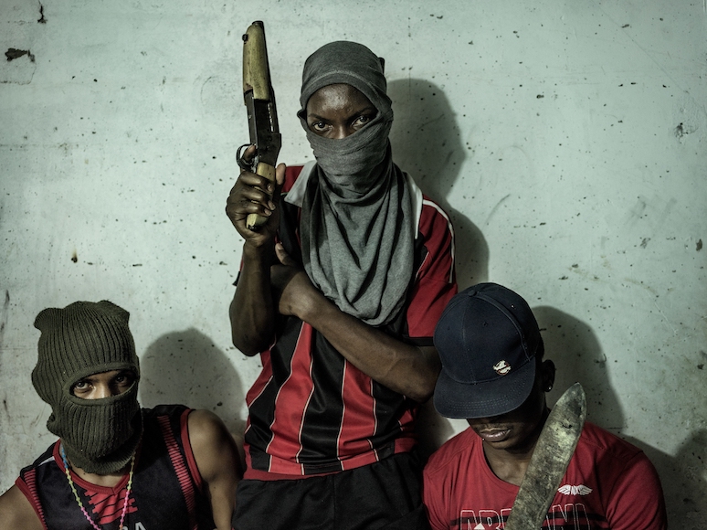 a group of men wearing masks and holding guns.