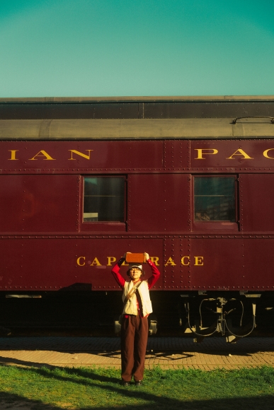 a person standing in front of a train.