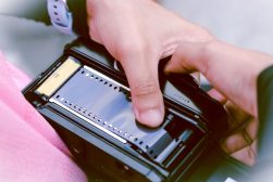 a person loading film into a camera