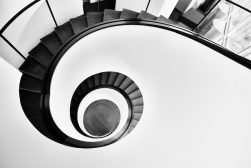 a black and white photo of a spiral staircase.