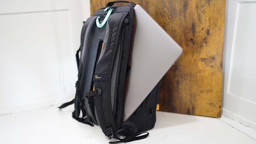 a black backpack with a laptop on top of it.