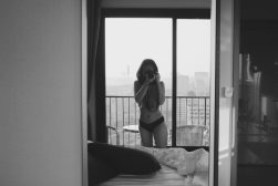 a woman taking a picture of herself in a hotel room.