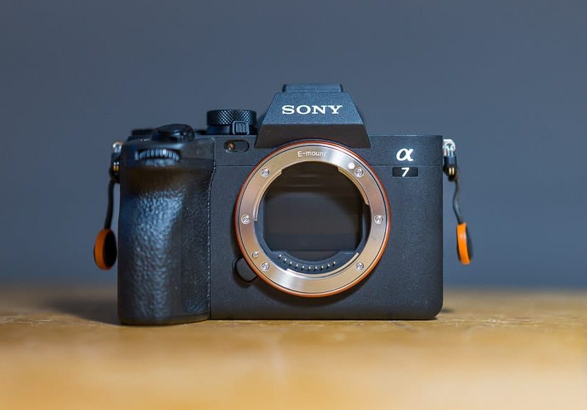 a Sony a7 IV camera sitting on top of a wooden table.