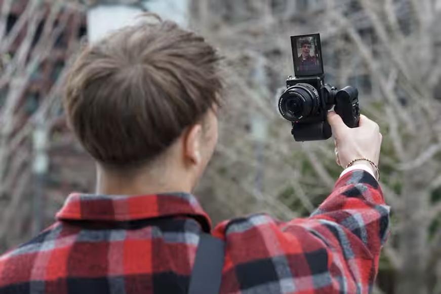 a person taking a picture with a camera.