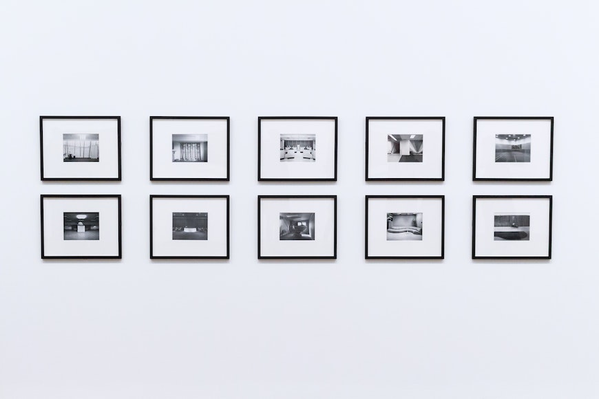 a group of black and white photographs hanging on a wall.