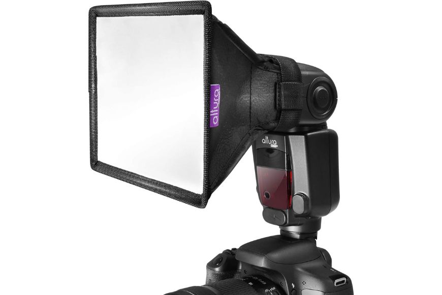 a flash light with mini soft box attached to it