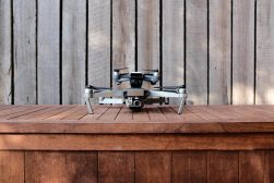 a small remote controlled flying drone on top of a wooden table.
