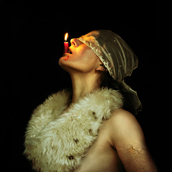 a woman with a candle in her mouth.