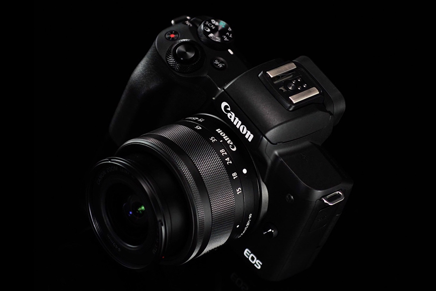 canon eos m50 mark ii camera with lens attached on a black back ground