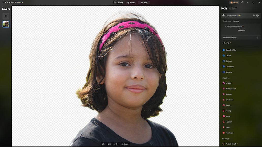 a little girl with a pink headband on.