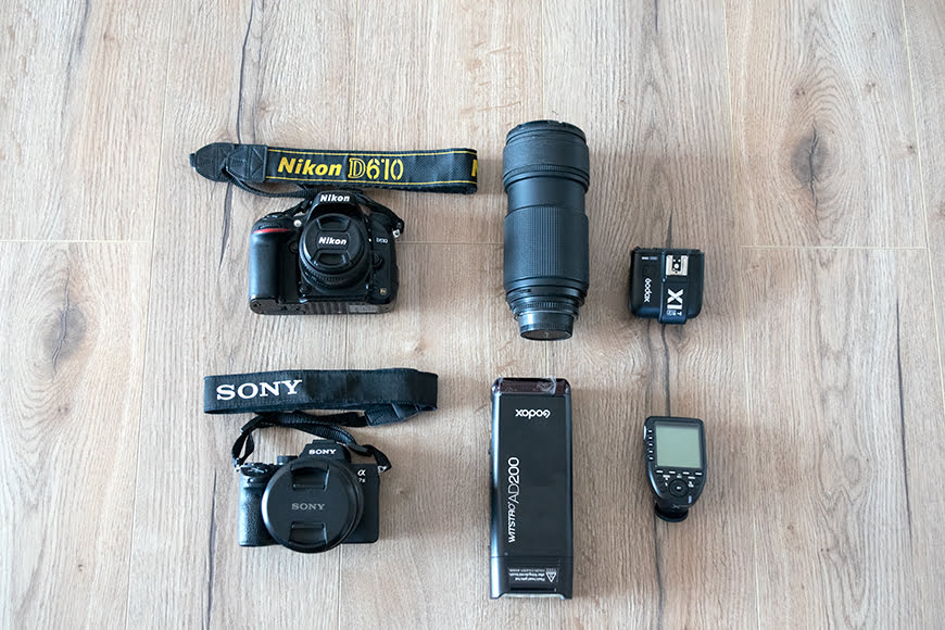a camera, flash, flash drive, flash drive, and other items laid out.