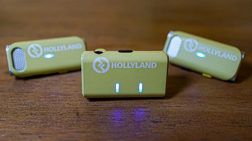 Hollyland electronic devices sitting on top of a wooden table.