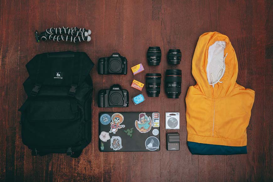 the contents of a camera bag laid out on a table.