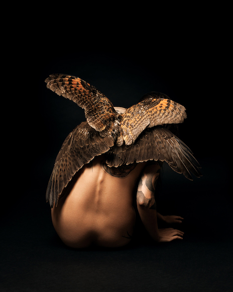 an image of a woman with an owl on her back.