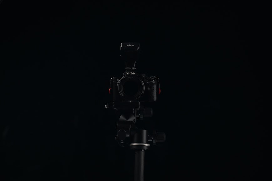a camera on a tripod in the dark.