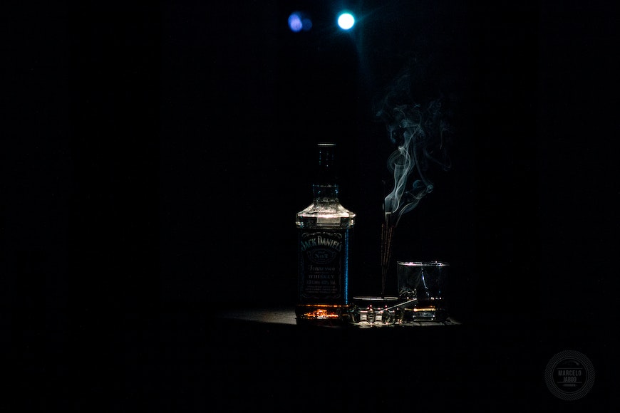 a bottle is lit up in the dark.
