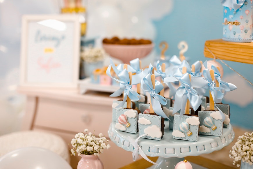 a blue and white baby shower with balloons and decorations.