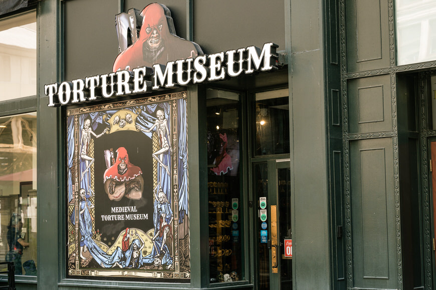 a storefront with a sign that says torture museum.
