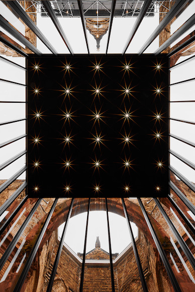the ceiling of a building with stars on it.