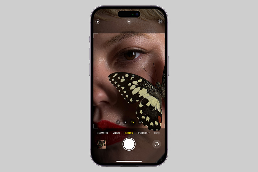 an image of a woman with a butterfly on her phone.