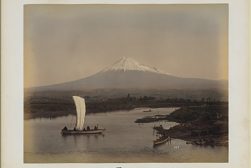a boat in the water with mount Fuji in the background.
