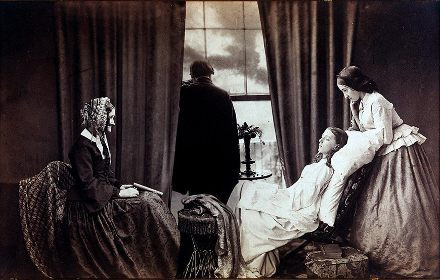three women sitting in a chair in front of a window.