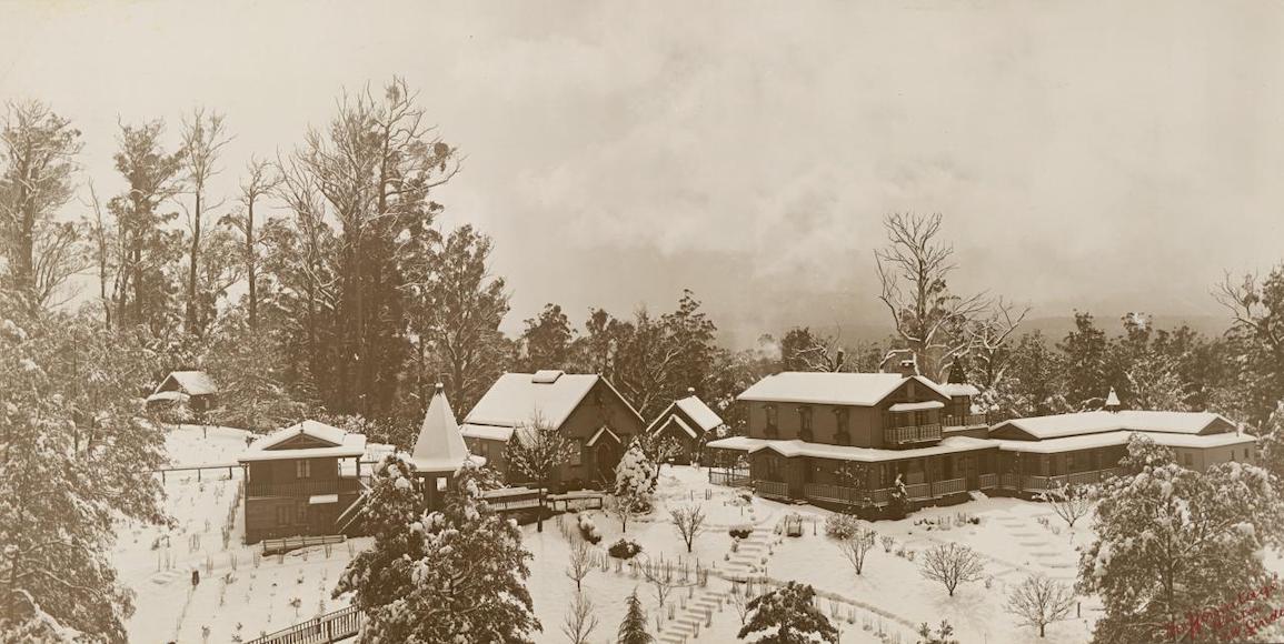 a black and white photo of a snow covered village taken by John William Lindt.