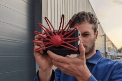 a man holding up a red and black spider.