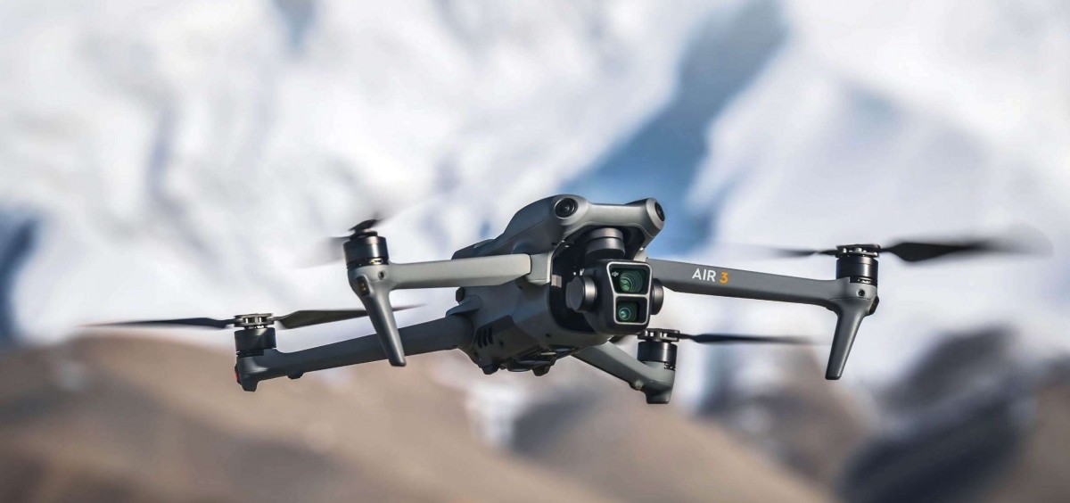 The dji mavic pro is flying in front of a mountain.