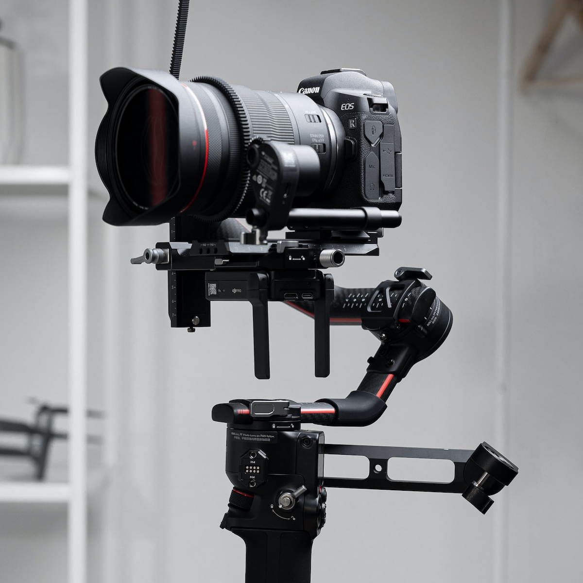 a canon gimbal with a camera attached to it.