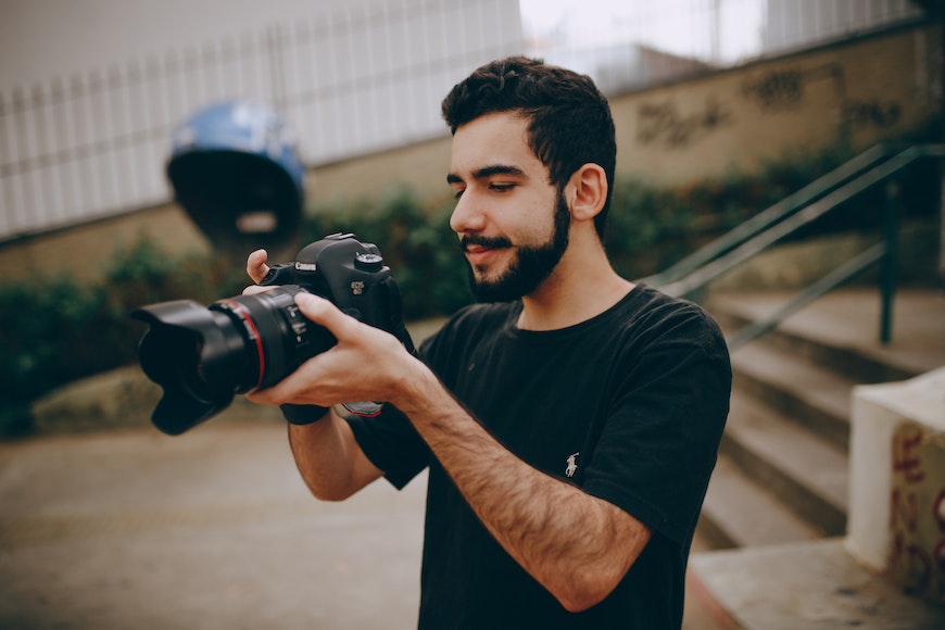 a man holding a camera and taking a picture.