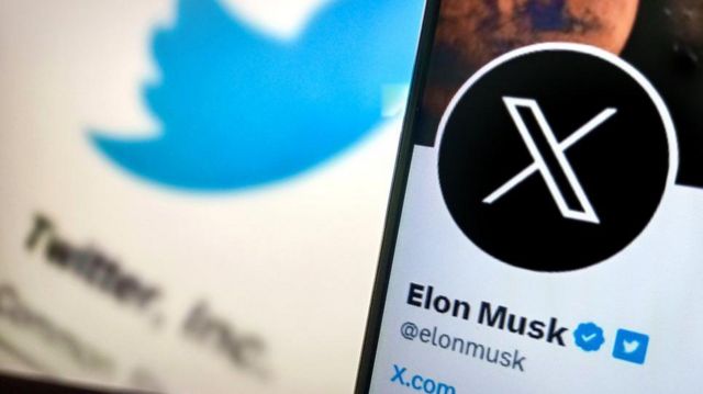 Elon musk's twitter logo is displayed on a smartphone.