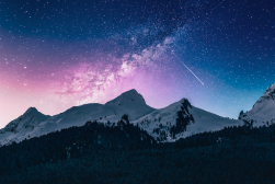 A mountain range with stars and milky in the sky.