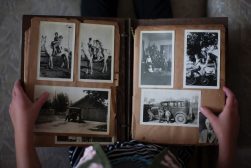 A person holding an old photo album.