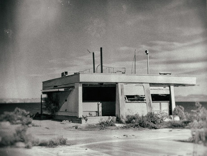 A black and white photograph of an abandoned building.