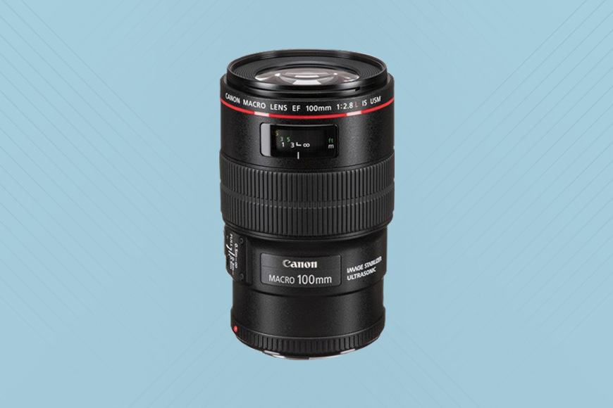 The Canon 100mm f/2.8L on a blue background.