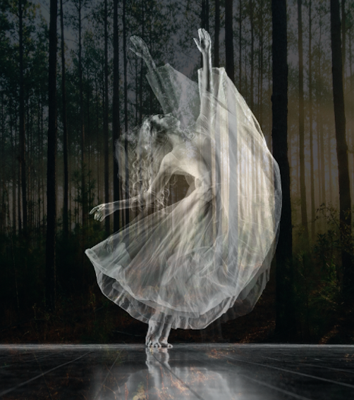 A woman in a white dress is dancing in the woods.