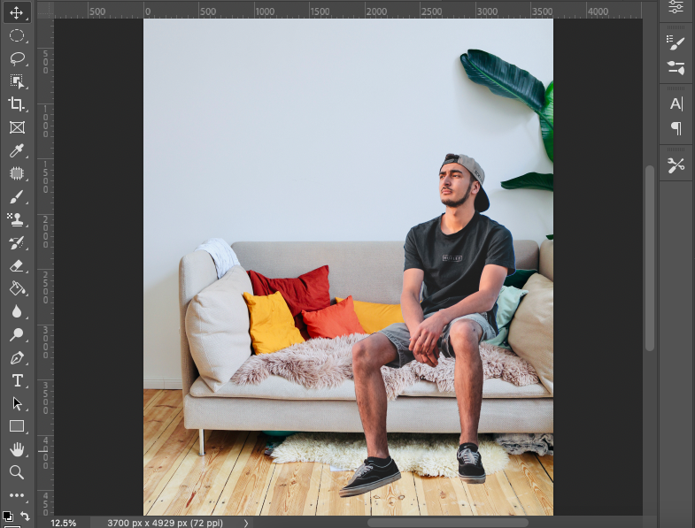 A man sitting on a couch in adobe photoshop.