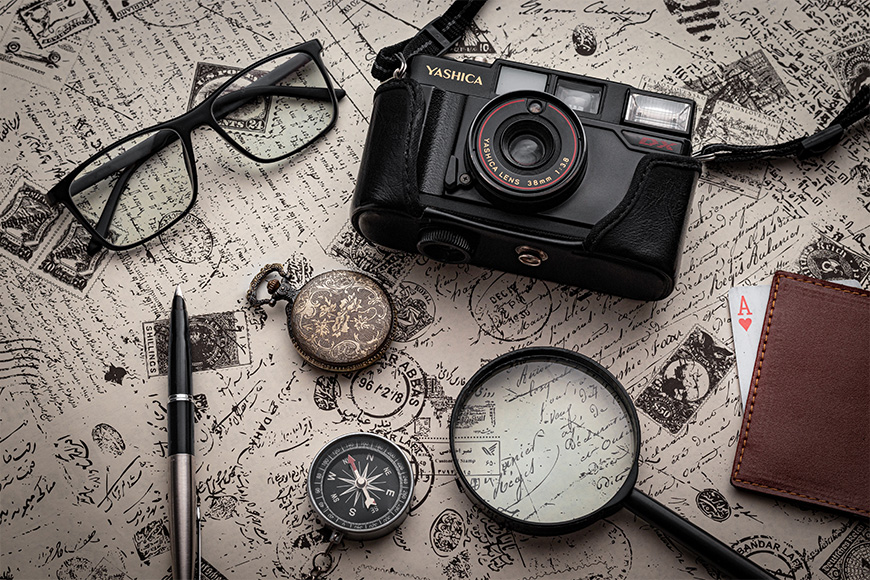 A camera, a magnifying glass, a compass and a magnifying glass.