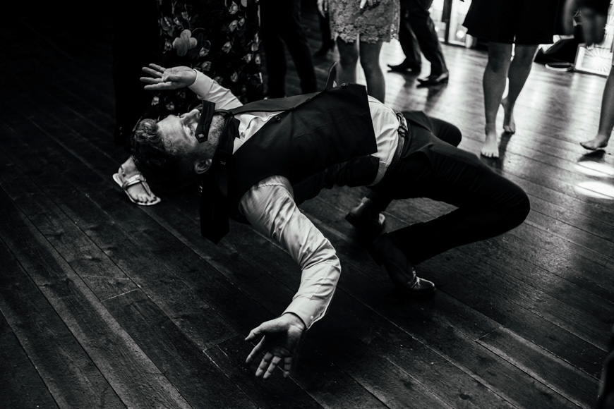 A man doing a flip on a dance floor.