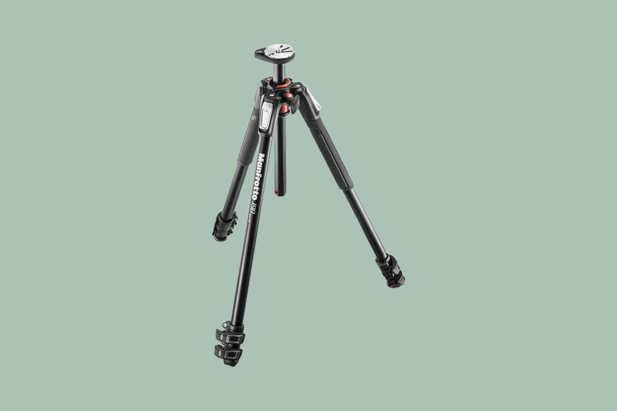 A Manfrotto MT190XPRO3 Aluminum 3-Section Tripodtripod on a green background.
