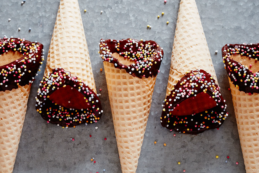 Ice cream cones with sprinkles and chocolate.