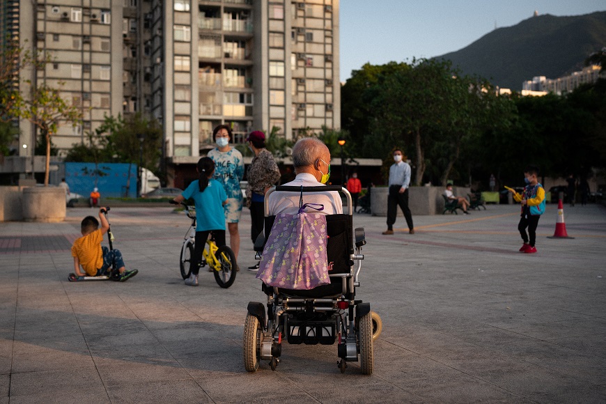 A man in a wheelchair in hong kong.