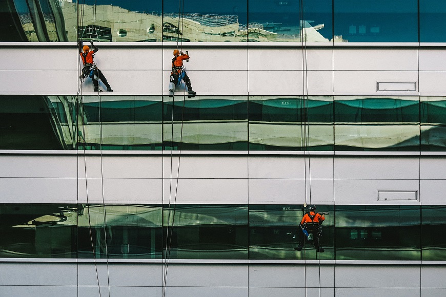 A group of window cleaners on the side of a building.