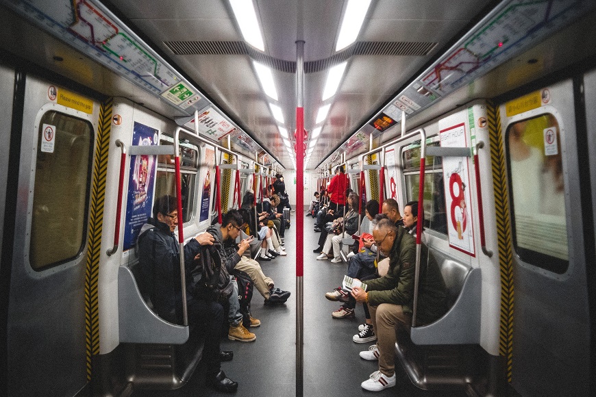 A group of people sitting on a subway train.