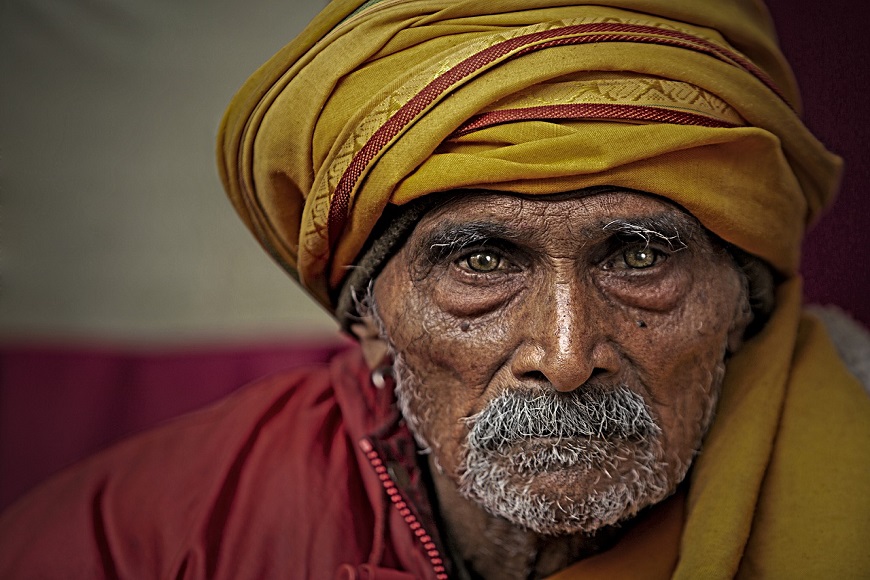 An indian man in a yellow turban.