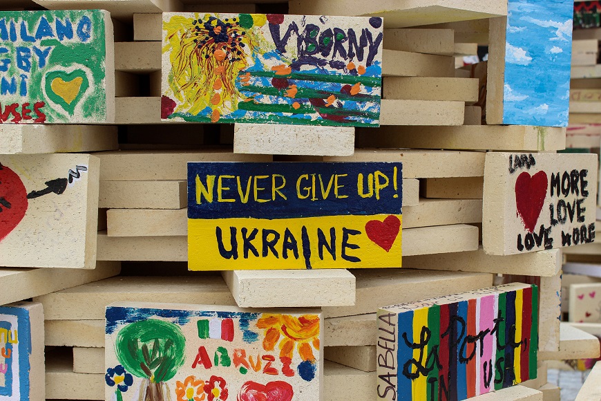 A stack of bricks with a message on them that says never give up ukraine.