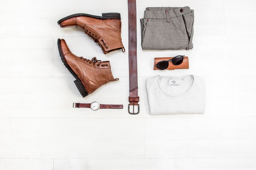 A man's outfit on a wooden floor.